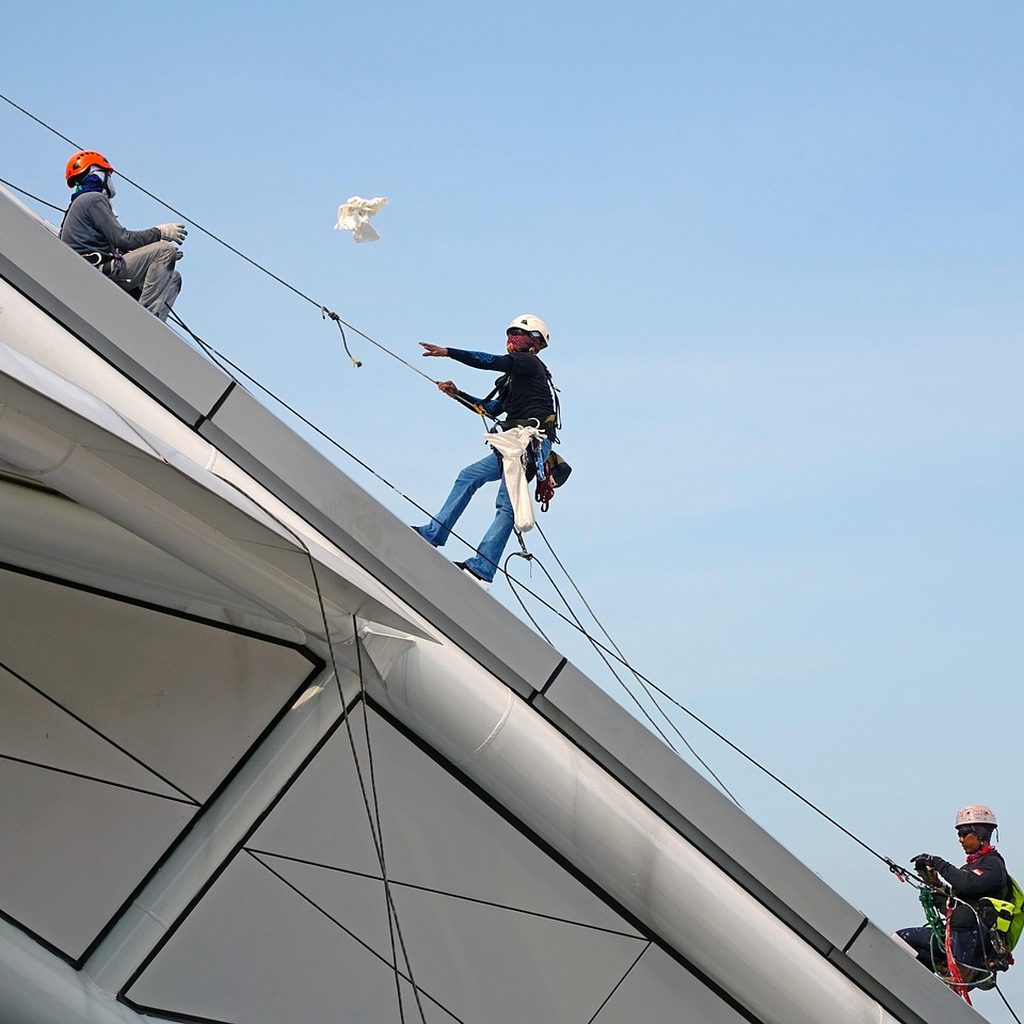 Professional roof repair team working on a residential project